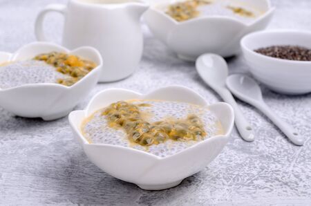 Dairy dessert chia seeds and passion fruit in a dish on a slate background. Selective focus.の写真素材