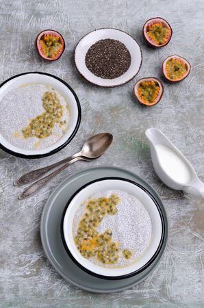 Dairy dessert chia seeds and passion fruit in a dish on a slate background. Selective focus.の写真素材