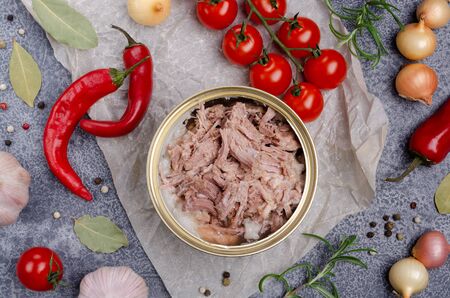 Canned meat in metal with vegetables and spices on a slate background. Selective focus.の写真素材