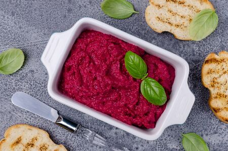Beet pate in a ceramic dish on a slate background. Selective focus.の写真素材