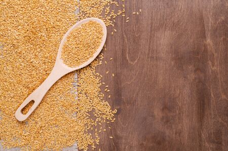 White flax seeds in a bowl. Wooden background and textiles. Selective focus.の写真素材