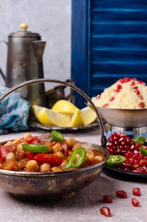 Stewed vegetables with chickpeas and couscous on a slate background. Selective focus.の写真素材