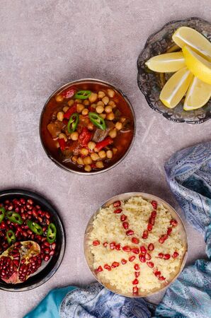 Stewed vegetables with chickpeas and couscous on a slate background. Selective focus.の写真素材