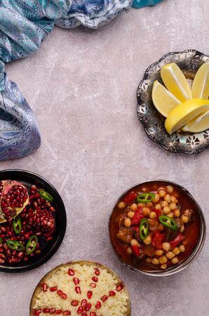 Stewed vegetables with chickpeas and couscous on a slate background. Selective focus.の写真素材