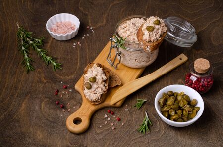 Fish pate with capers and rye bread on a wooden background. Selective focus.の写真素材