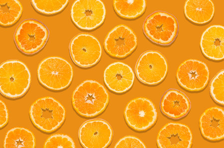 Orange fruit slices on an orange background. Design concept.