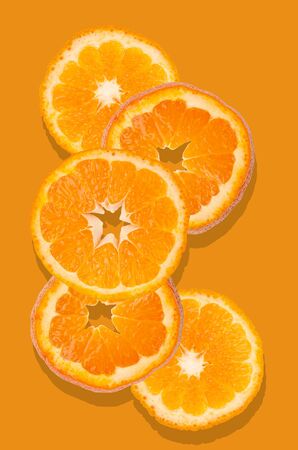 Orange fruit slices on an orange background. Design concept.の写真素材