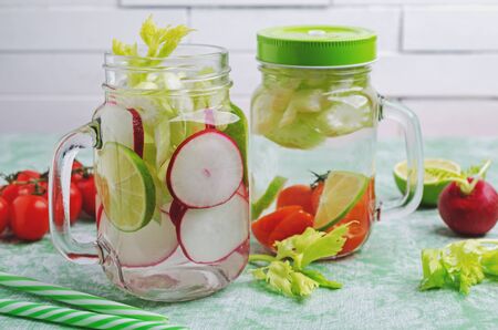 Infused water with vegetables and citrus in glass. Selective focus.の写真素材