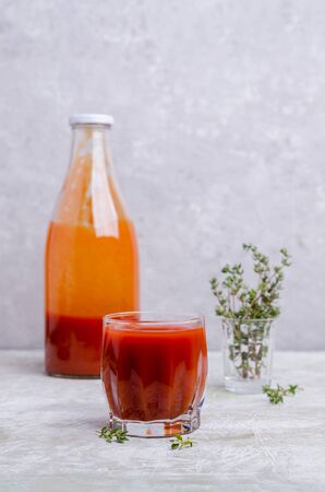 Thick red vegetable juice in glass on a light background. Selective focus.の写真素材