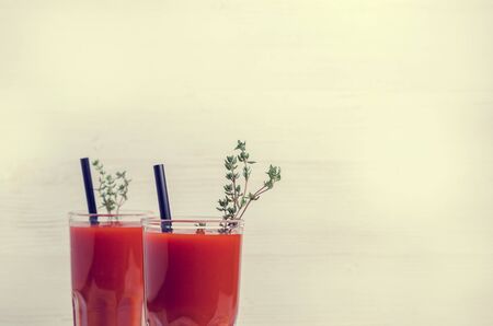 Thick red vegetable juice in glass on a light background. Selective focus.の写真素材