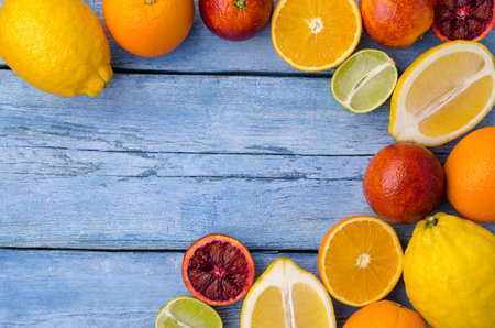 Fresh citrus fruits on an old blue background. Design concept. Selective focus.
