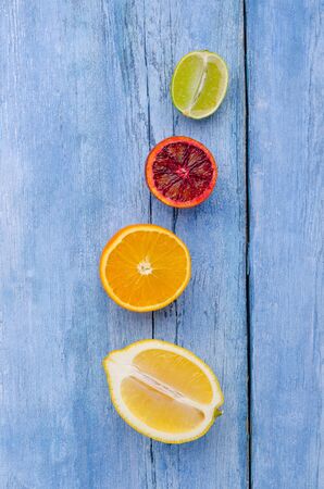 Fresh citrus fruits on an old blue background. Design concept. Selective focus.の写真素材