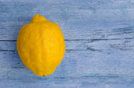 Fresh citrus fruits on an old blue background. Design concept. Selective focus.