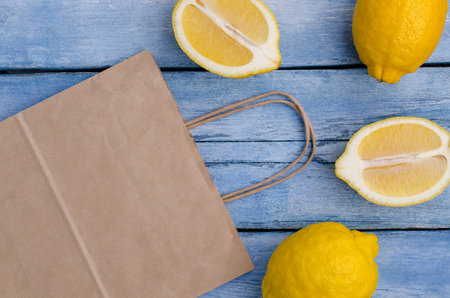 Fresh lemons on an old blue background. Design concept. Selective focus.の写真素材