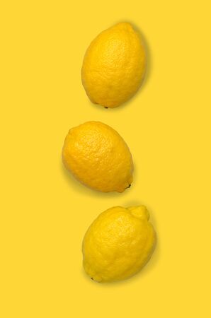 Fresh yellow lemons on an old blue background. Design concept. Selective focus.の写真素材