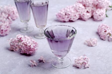 Transparent lilac drink in glass on a slate background. Selective focus.の写真素材