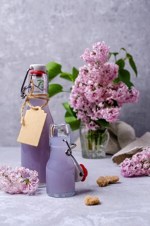 Lilac drink in a glass on a slate background. Selective focus.の写真素材