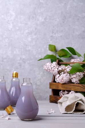 Lilac drink in a glass on a gray background. Selective focus.の写真素材