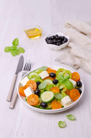 Salad raw vegetables and cheese in a dish on a wooden background. Selective focus.の写真素材