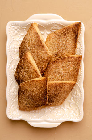 Traditional shortbread cookies with cinnamon and sugar on a stone background. Selective focus.