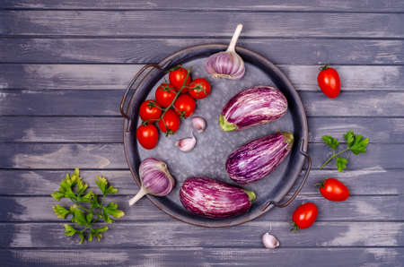 Raw vegetables with a metal dish on a gray wooden background. Selective focus.の写真素材