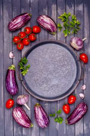 Raw vegetables with a metal dish on a gray wooden background. Selective focus.の写真素材
