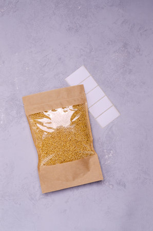 Fine dry paste in paper packaging on a gray stone background. Selective focus.の写真素材