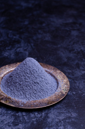Traditional blue tea powder on a dark background. Selective focus.の写真素材