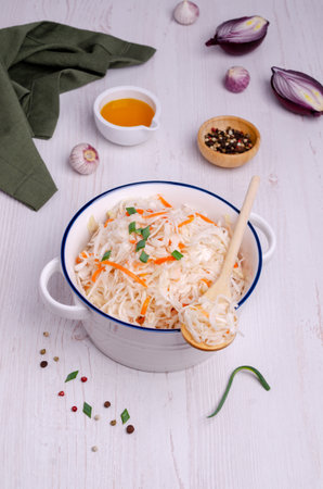 Sauerkraut salad with carrots in a dish on a wooden background. Selective focus.の写真素材