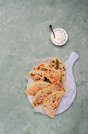 Baked bread with vegetable filling on a stone background. Selective focus.