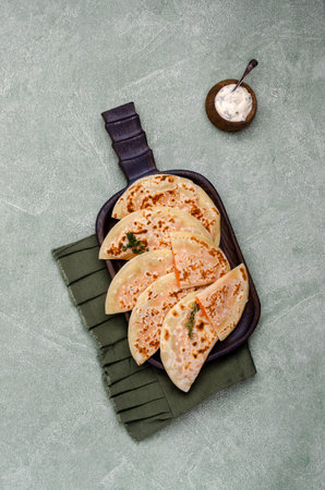 Baked bread with vegetable filling on a stone background. Selective focus.