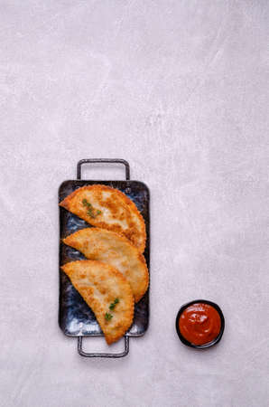 Fried burekas with filling on a light stone background. Top view. Selective focus.の写真素材