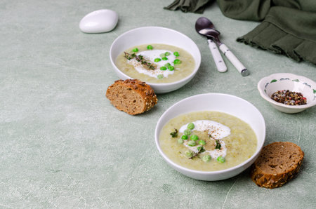 Thick vegetable soup with yogurt on a green stone background. Selective focus.