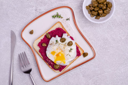 Sandwich with beetroot sauce and egg on a stone background. Top view. Selective focus.