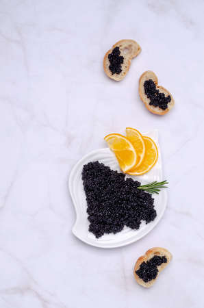 Organic black caviar in a dish on a light background. Selective focus.の写真素材