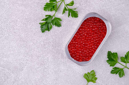 Fish roe in a tin container with parsley leavesの写真素材