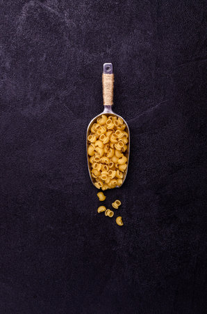 Traditional dry pasta on a black background. Design concept. A copy of the space. Selective focus.