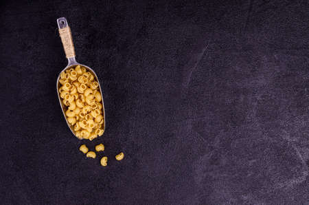 Traditional dry pasta on a black background. Design concept. A copy of the space. Selective focus.の写真素材