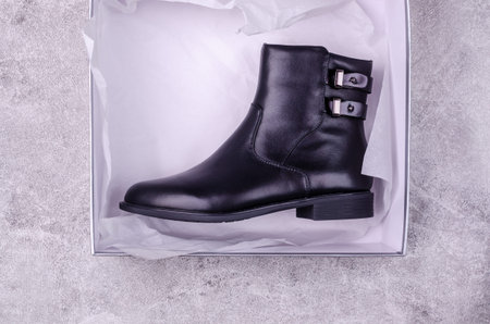 New black womens boots on a gray background. Design concept. Selective focus.