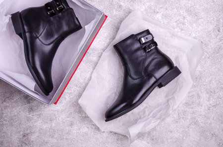 New black womens boots on a gray background. Design concept. Selective focus.の写真素材
