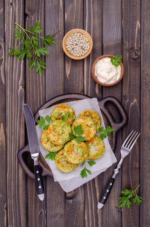 Fried vegetable cutlets with white sauce on a wooden background. Selective focus.の写真素材