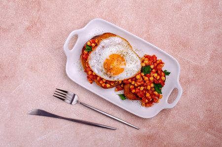 Sandwich with tomatoes and chickpeas and fried egg. Selective focus.の写真素材