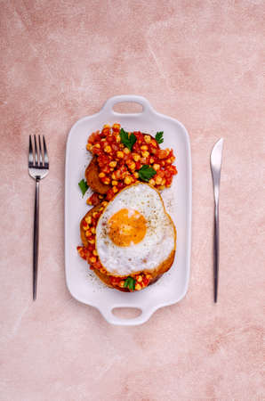 Sandwich with tomatoes and chickpeas and fried egg. Selective focus.の写真素材