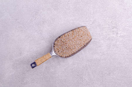 White chia seeds in a metal scoop on a gray background. Selective focus.の写真素材