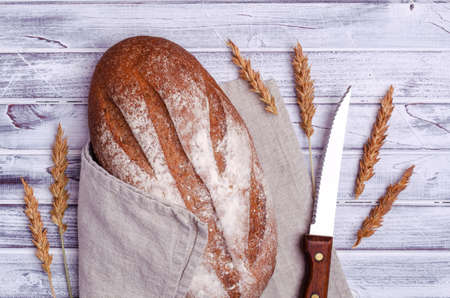 Traditional dark bread on a light wooden background. Top view.の写真素材