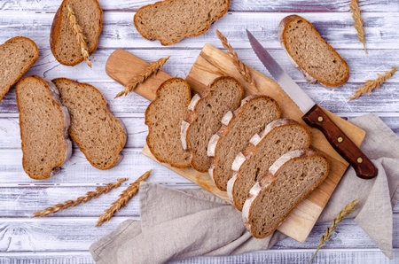 Traditional dark bread on a light wooden background. Top view.の写真素材
