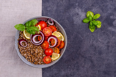 Salad with buckwheat and vegetables on a cement background. Selective focus.の写真素材