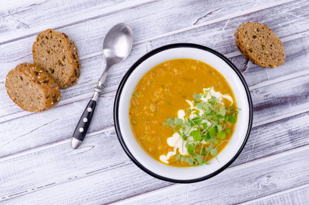 Thick soup with lentils and vegetables on a wooden background. Selective focus.の写真素材