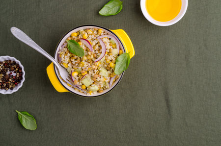Lentil salad with wheat and vegetables in a ceramic dish on a textile background. Selective focus.の写真素材