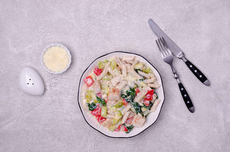 Traditional pasta with poultry and vegetables in a white sauce. Top view. Selective focus.の写真素材